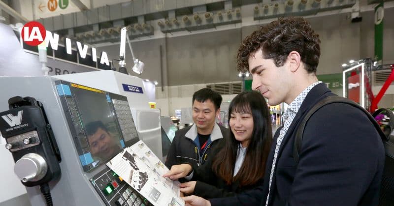 International buyers attentively listening to exhibitors' product presentations