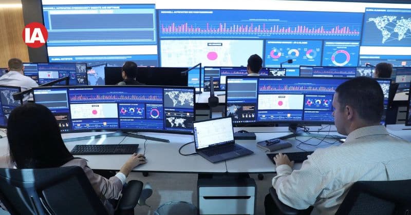 Pharmaceutical worker at monitors with FactoryTalk PharmaSuite software running